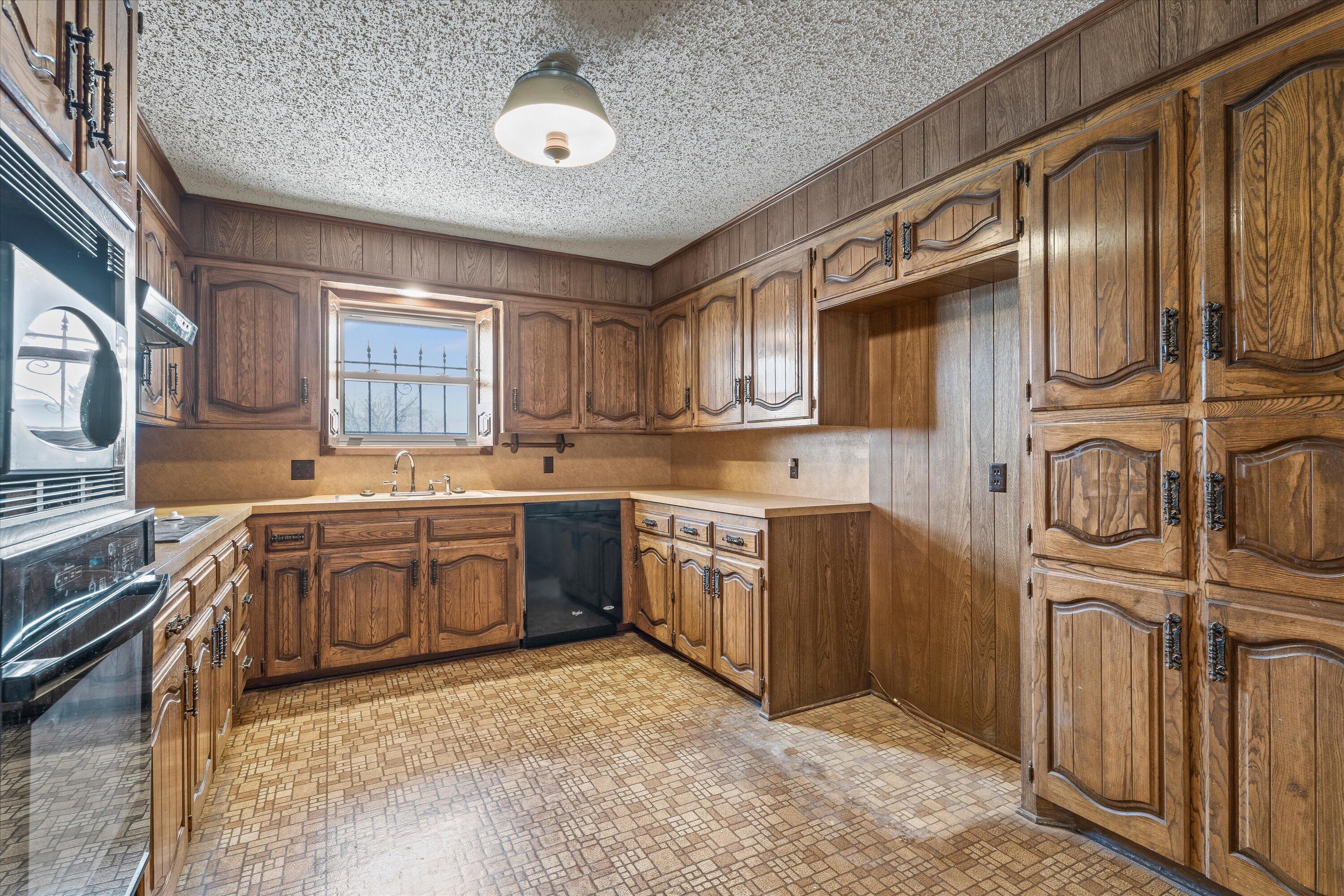 308 West 6th Street Sundown, TX 79372 - Photo 9 of 33 a kitchen with stainless steel appliances granite countertop a sink stove and cabinets