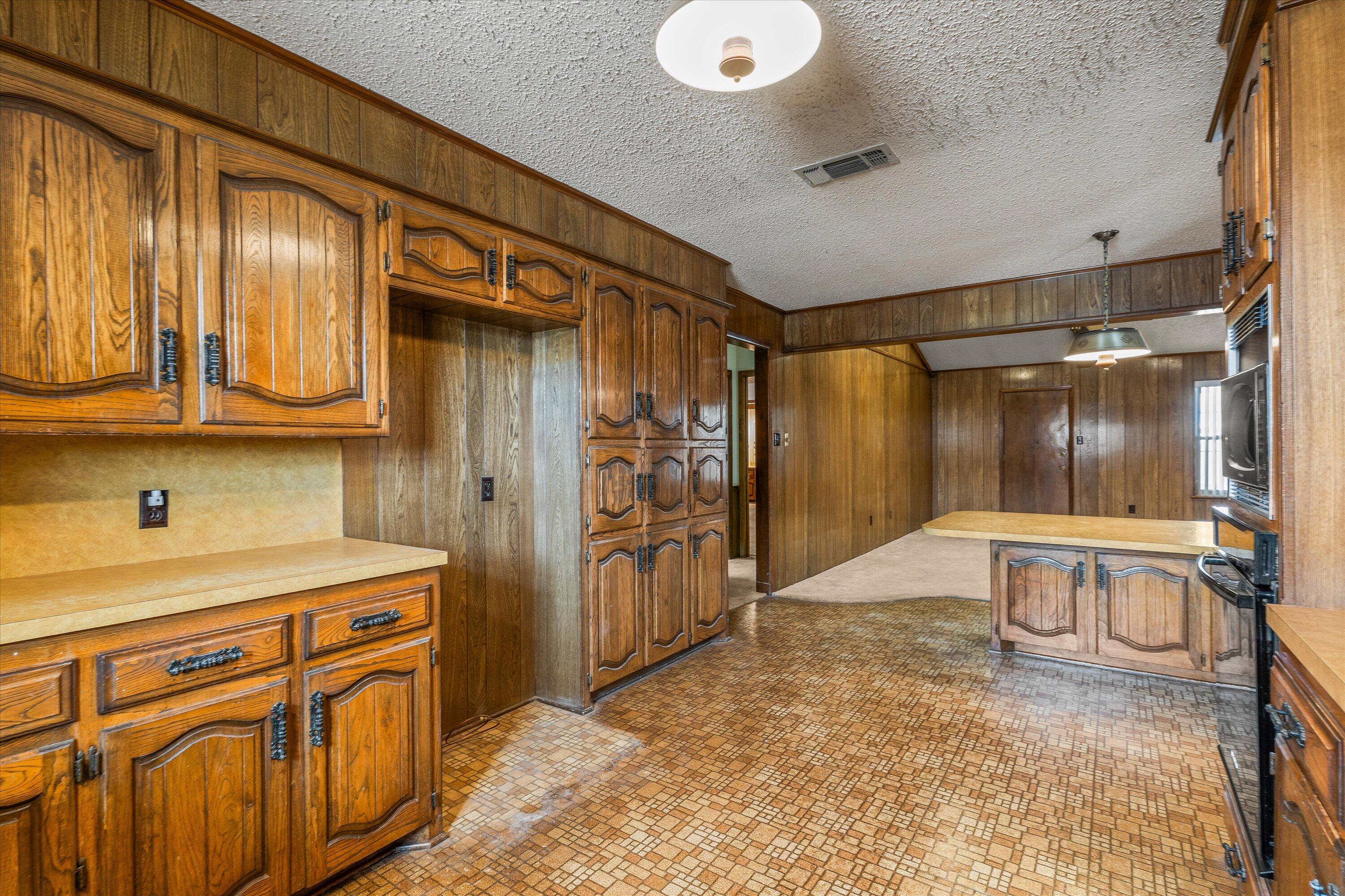 308 West 6th Street Sundown, TX 79372 - Photo 10 of 33 a kitchen with stainless steel appliances granite countertop a refrigerator and cabinets