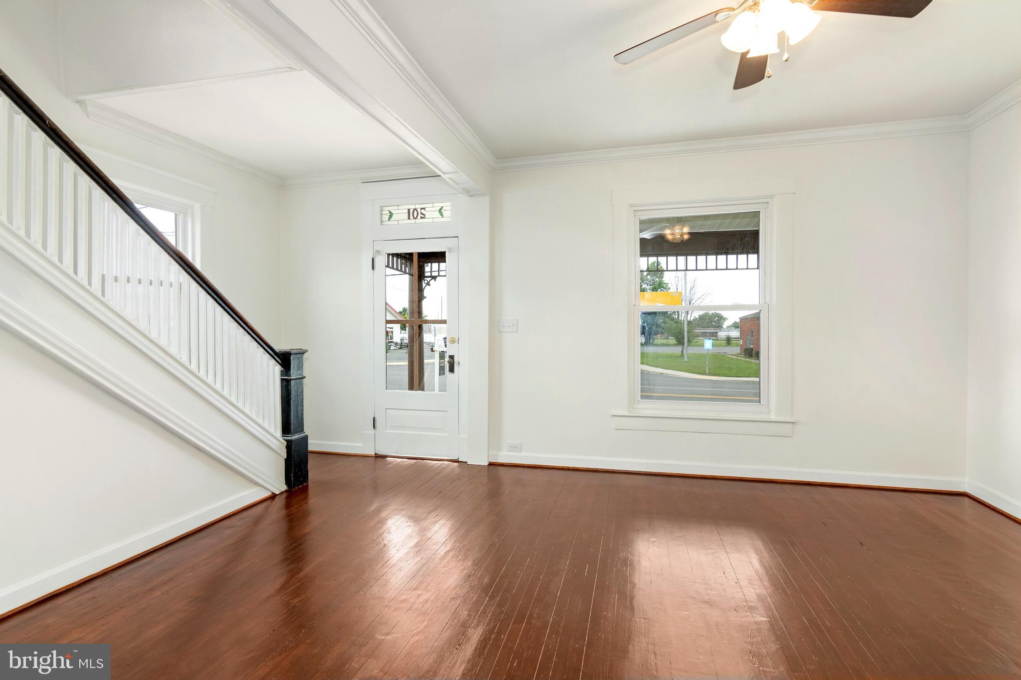 a view of an entryway with wooden floor and stairs