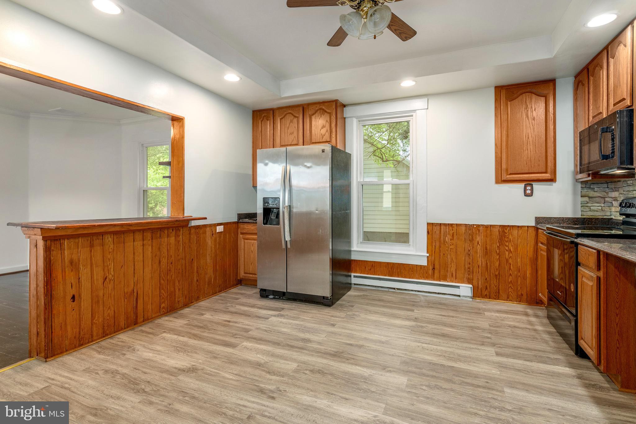 201 Washington Street Cambridge, MD 21613 - Photo 13 of 31 a kitchen with stainless steel appliances granite countertop a refrigerator and a sink