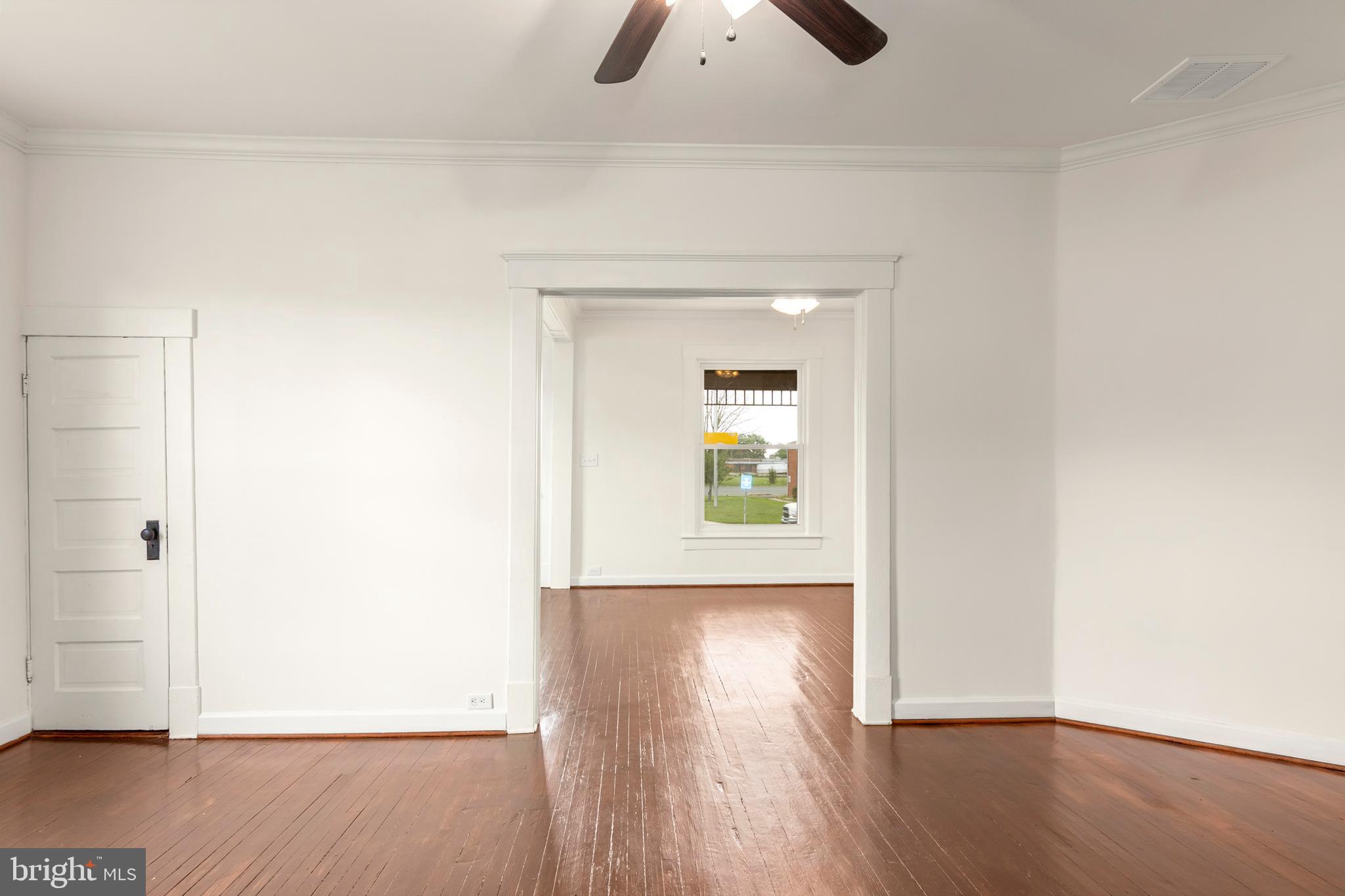 201 Washington Street Cambridge, MD 21613 - Photo 17 of 31 an empty room with wooden floor cabinet and windows
