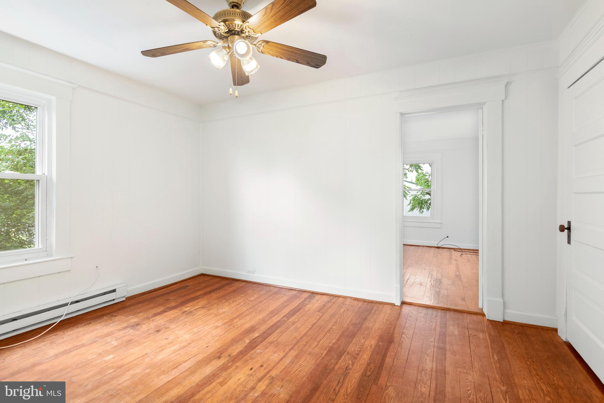 201 Washington Street Cambridge, MD 21613 - Photo 22 of 31 wooden floor in an empty room with a window