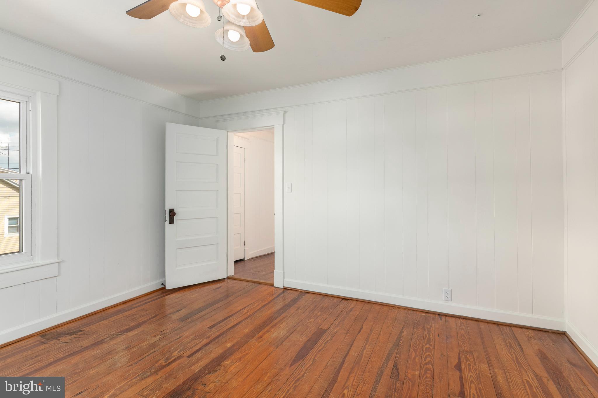 201 Washington Street Cambridge, MD 21613 - Photo 25 of 31 a view of an empty room with wooden floor and a window