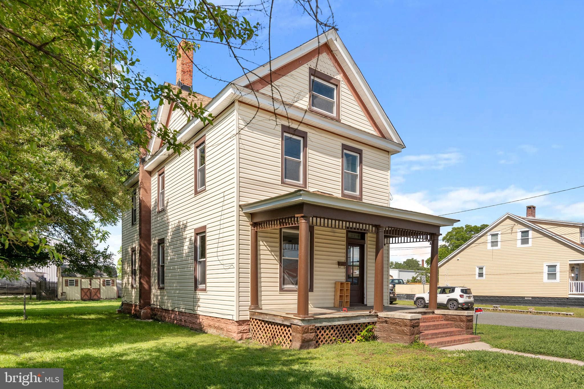 201 Washington Street Cambridge, MD 21613 - Photo 6 of 31 a view of a white house with a yard and plants