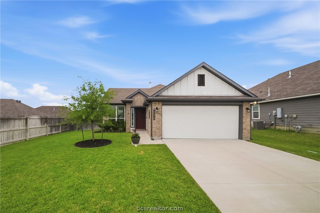 203 36th Ridge Caldwell, TX 77836 - Photo 1 of 31 a front view of a house with a yard and garage