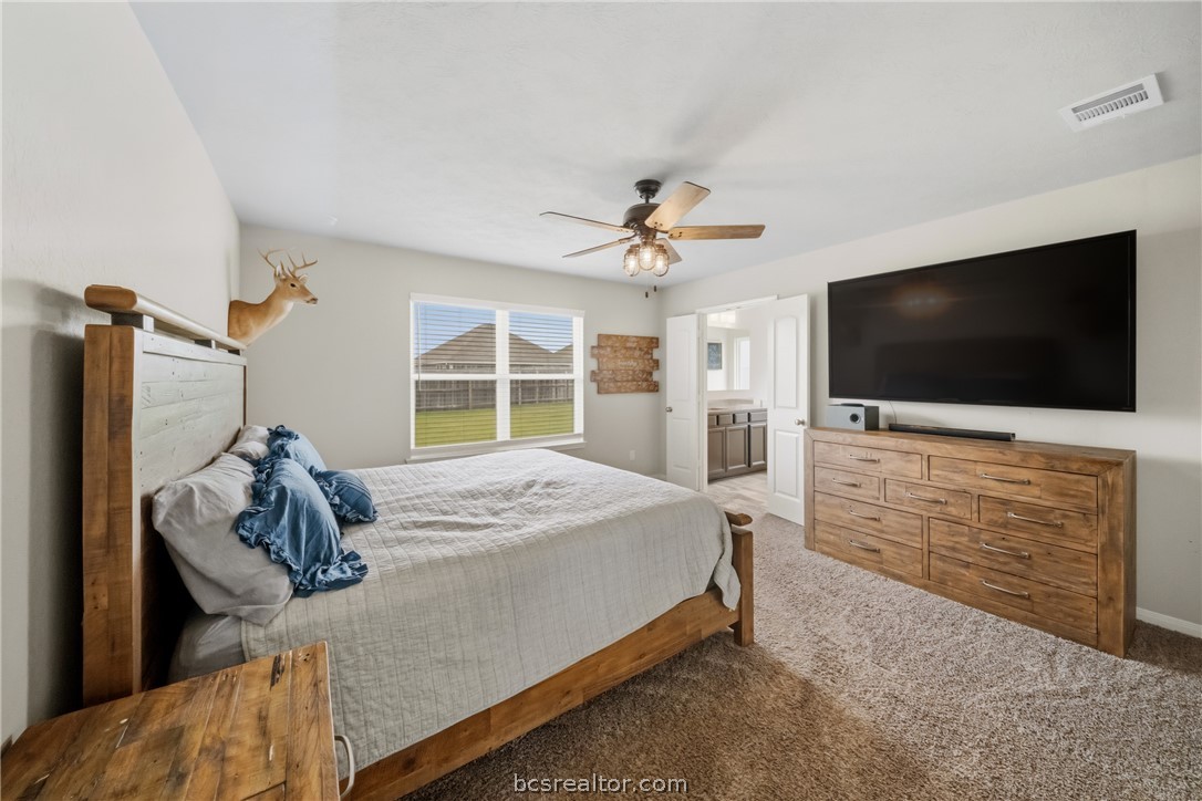 203 36th Ridge Caldwell, TX 77836 - Photo 11 of 31 a bedroom with a bed and a flat tv screen on dresser