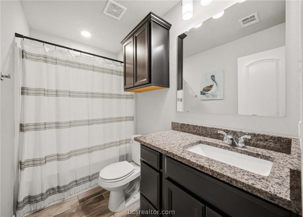 203 36th Ridge Caldwell, TX 77836 - Photo 19 of 31 a bathroom with a granite countertop sink toilet and shower