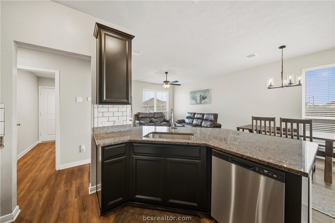 203 36th Ridge Caldwell, TX 77836 - Photo 10 of 31 a kitchen with stainless steel appliances granite countertop a sink a stove and a refrigerator