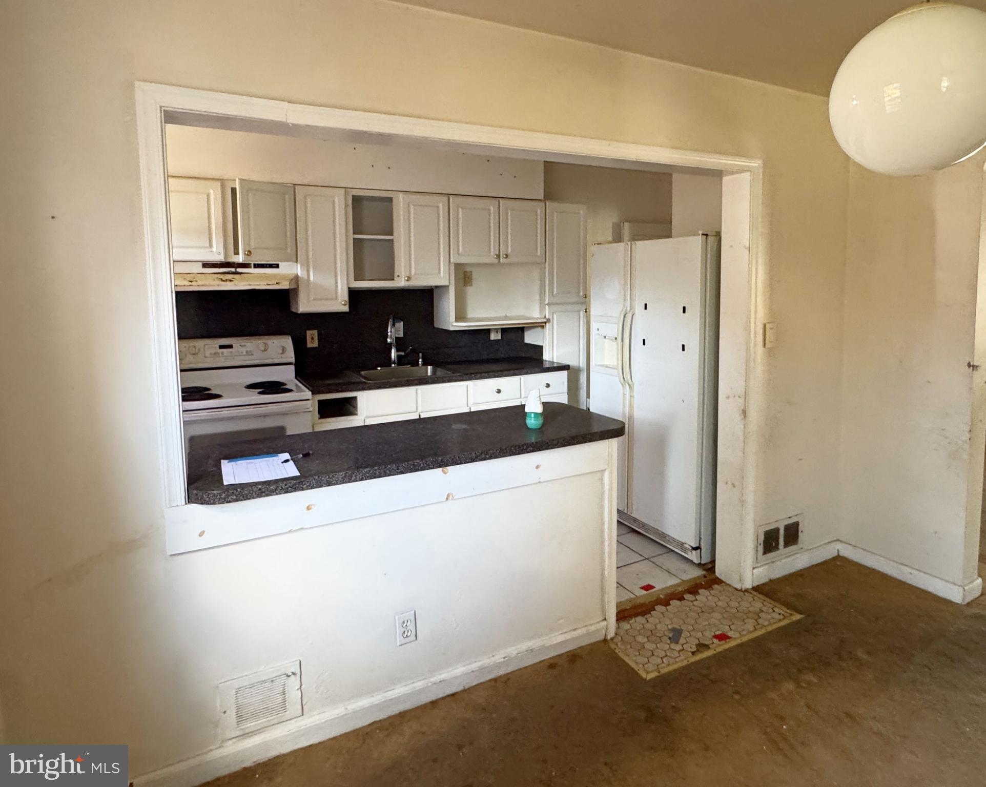 44 North Athol Avenue Baltimore, MD 21229 - Photo 8 of 18 a kitchen with granite countertop a sink and cabinets