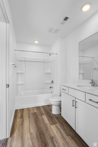 2194 Wolverine Way, Unit 2531 Washington, UT 84780 - Photo 29 of 52 Full bathroom featuring wood-finish flooring, a white vanity with a rectangular sink, a combination shower-tub unit, and recessed lighting