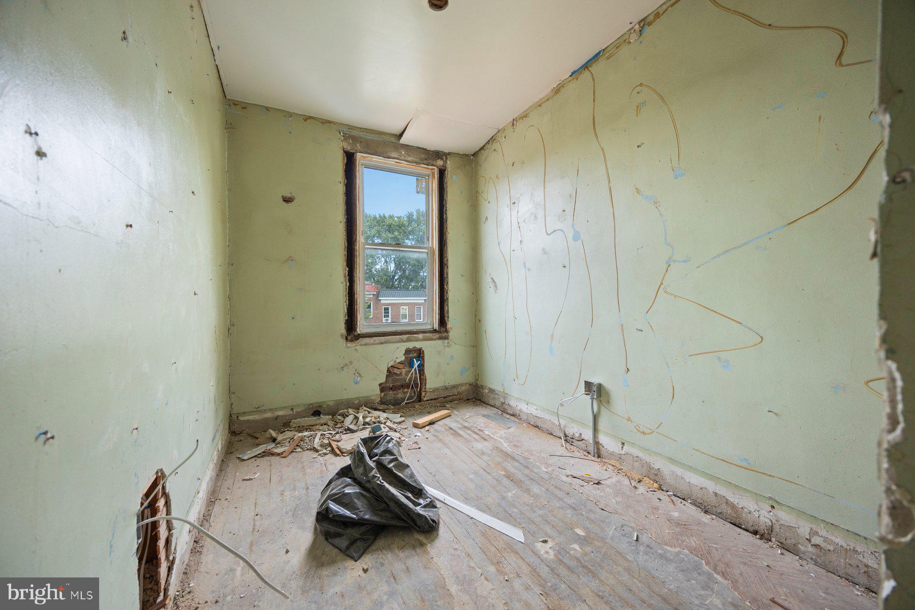 2906 Violet Avenue Baltimore, MD 21215 - Photo 18 of 30 a room with a bed and a window