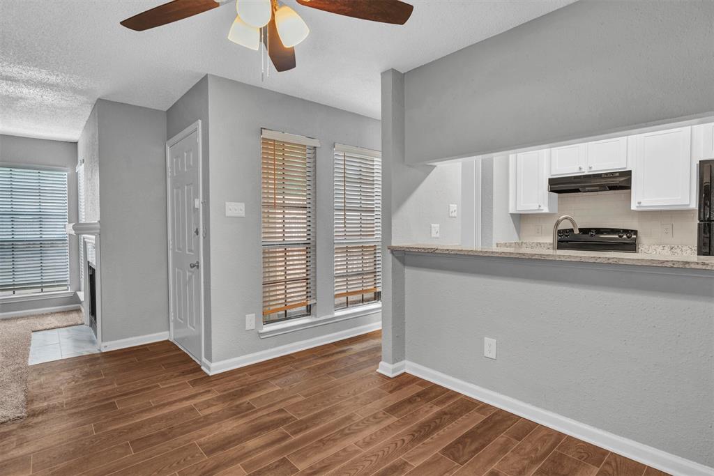 11311 Audelia Road, Unit 221 Dallas, TX 75243 - Photo 5 of 22 a kitchen with wooden floors and wide window