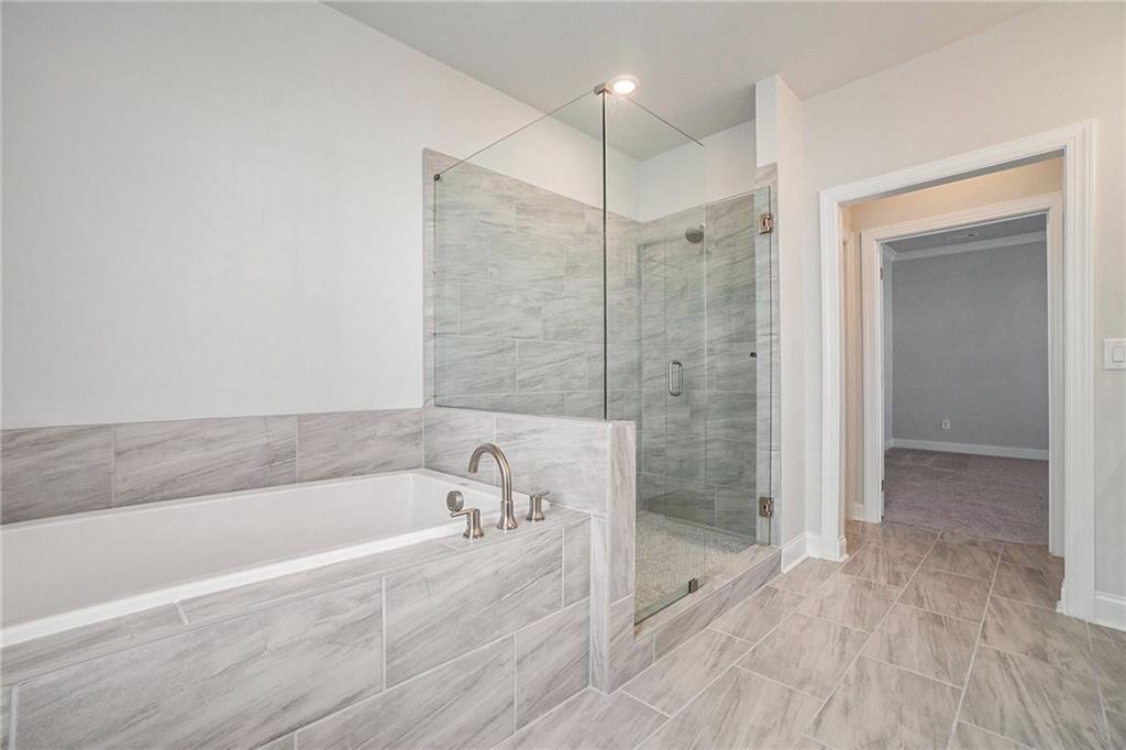 106 Basil Street Cumming, GA 30040 - Photo 15 of 25 a spacious bathroom with a bathtub and a shower