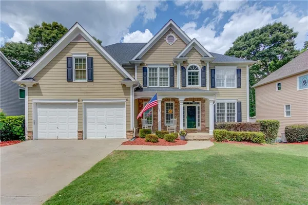a front view of house with yard and green space