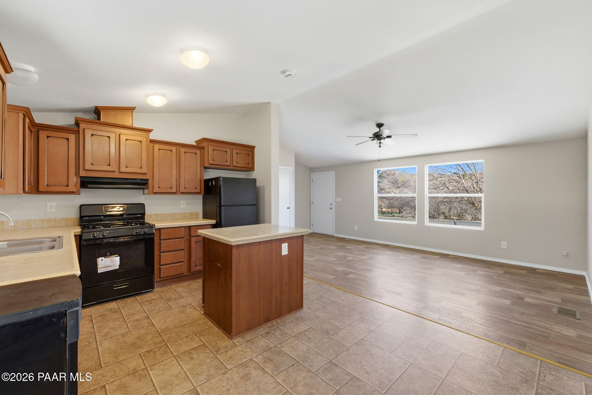 10397 East Durham Road Dewey, AZ 86327 - Photo 15 of 40 a kitchen with stainless steel appliances granite countertop a stove top oven a sink a counter space and cabinets