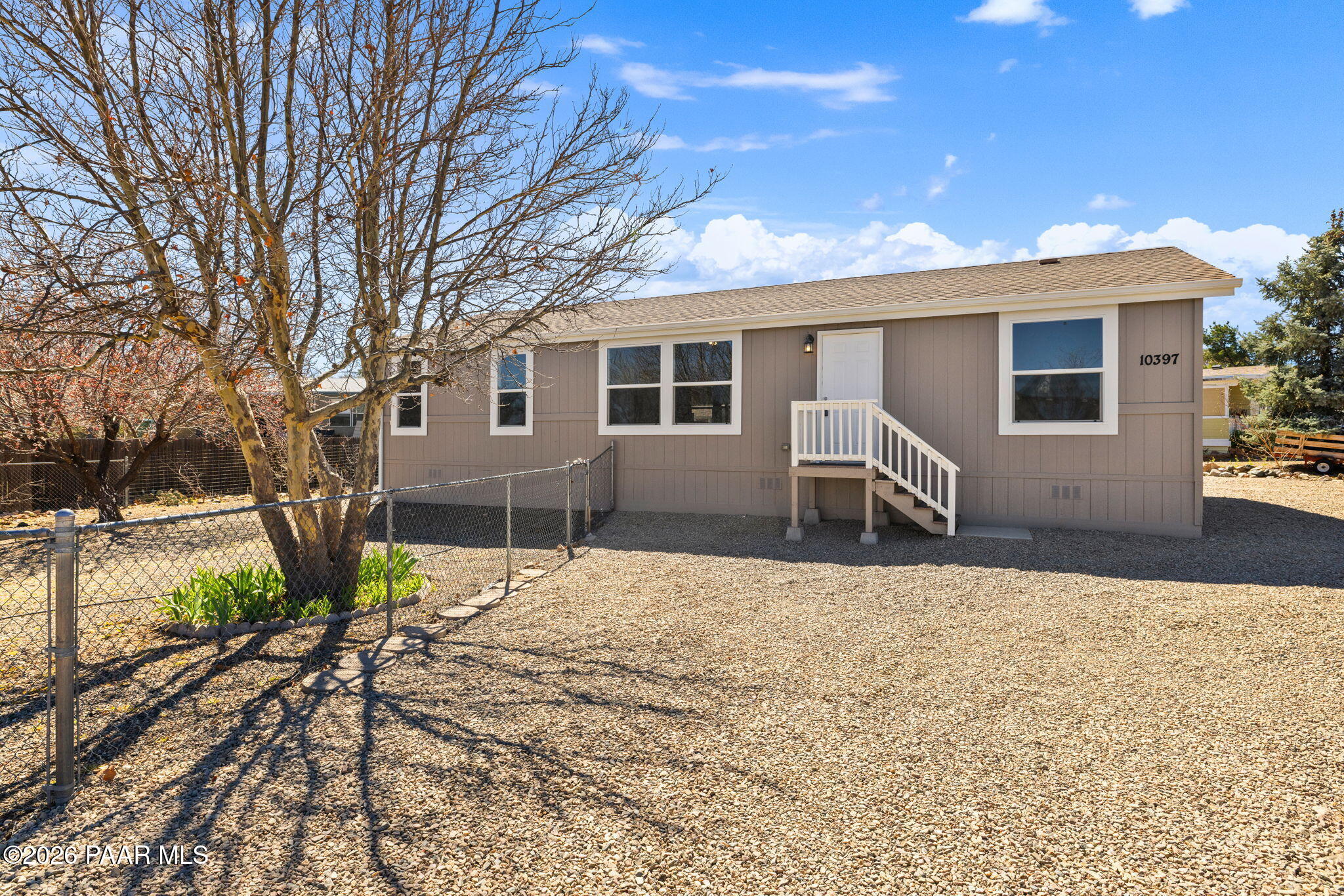 10397 East Durham Road Dewey, AZ 86327 - Photo 2 of 40 a backyard of a house with table and chairs