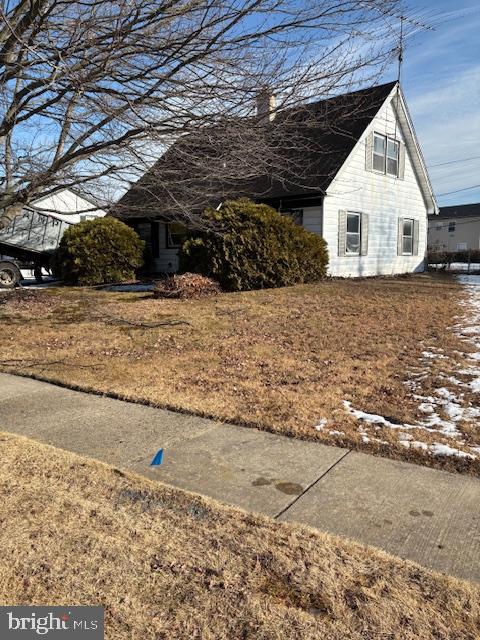 a view of a wooden house with a yard