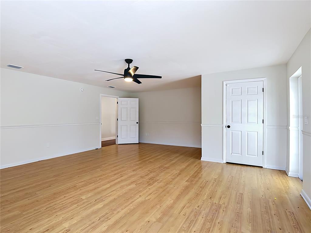 7925 Lake Mabel Loop Road Lake Wales, FL 33898 - Photo 35 of 97 a view of empty room with wooden floor and fan