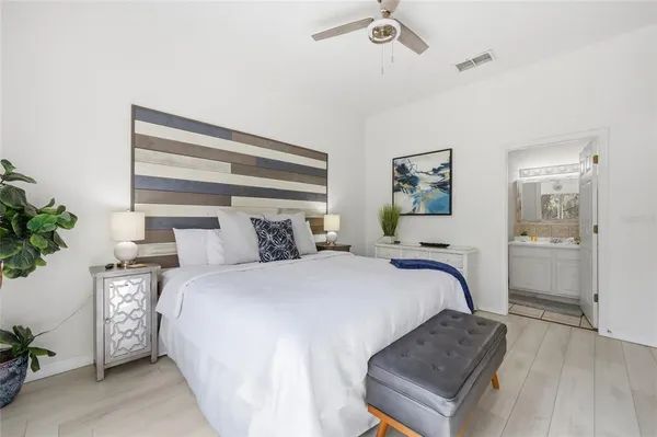 a bedroom with a bed and a potted plant