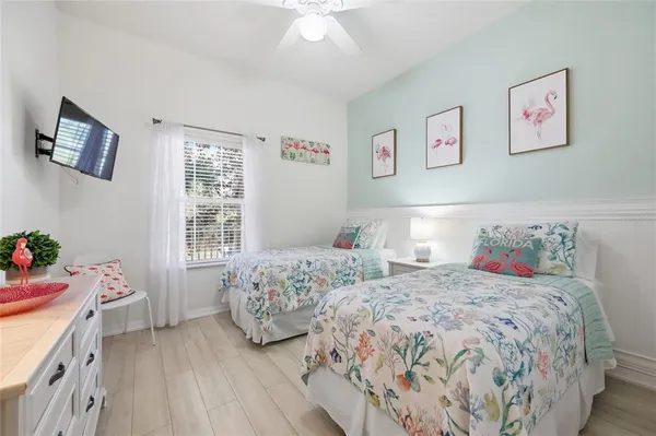 a bedroom with two beds and a window