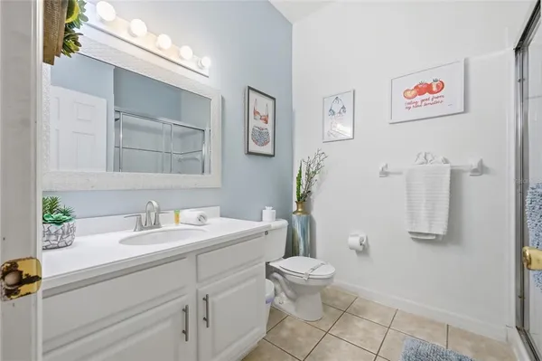 a bathroom with a sink mirror vanity and toilet