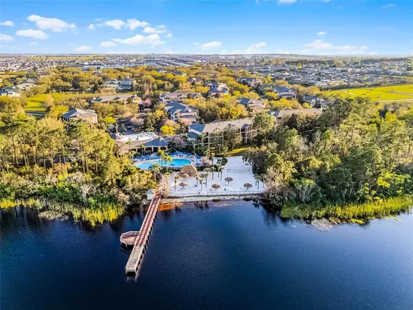 an aerial view of residential houses with outdoor space and swimming pool