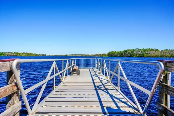 a view of a roof deck with wooden floor and fence