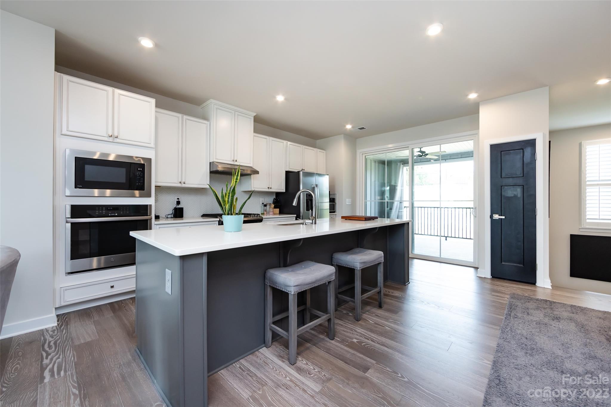 606 Crudent Road Tega Cay, SC 29708 - Photo 11 of 47 a kitchen with kitchen island granite countertop a sink appliances and cabinets