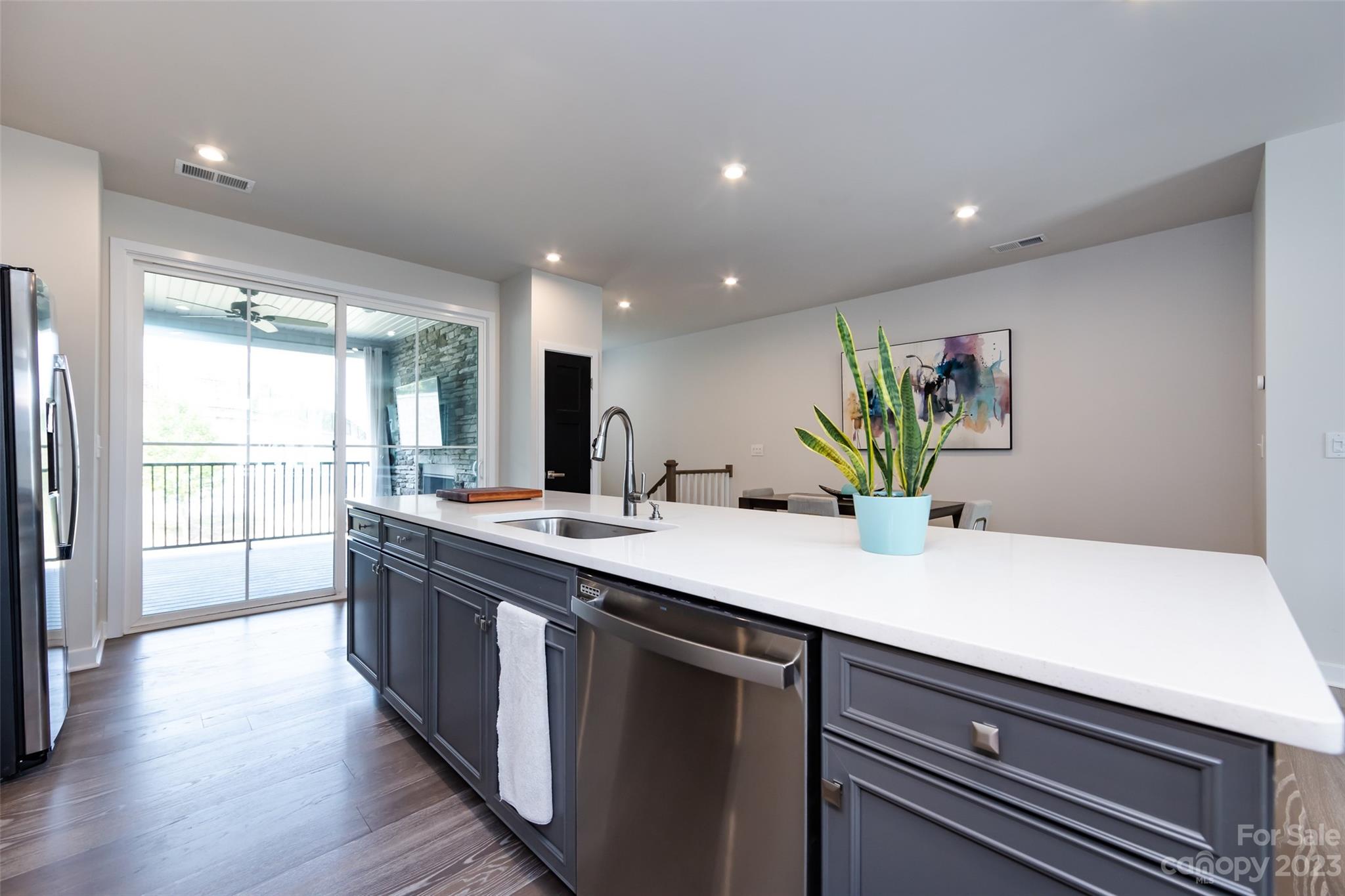 606 Crudent Road Tega Cay, SC 29708 - Photo 14 of 47 a kitchen with kitchen island a sink appliances and a large window