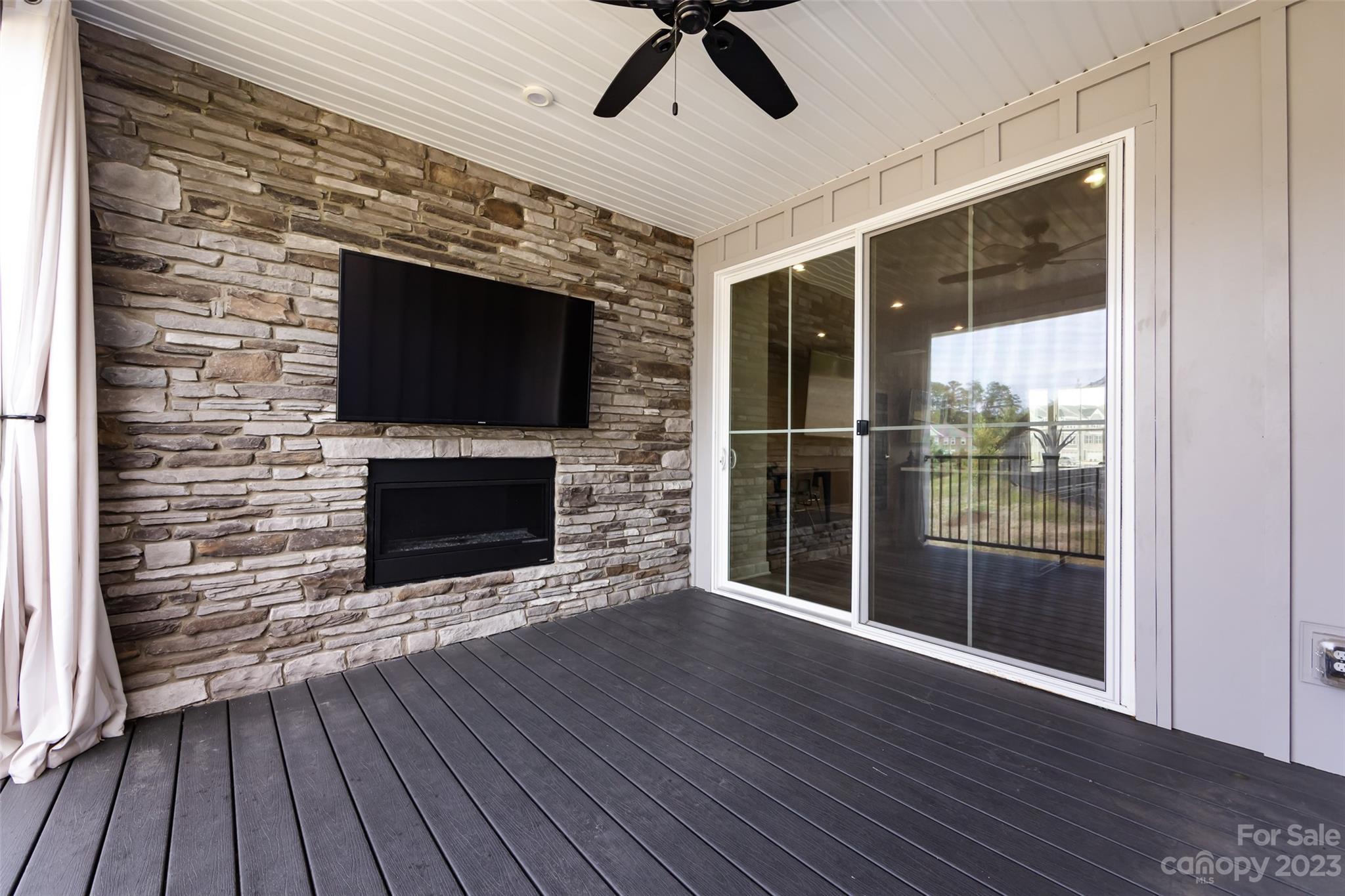 606 Crudent Road Tega Cay, SC 29708 - Photo 18 of 47 a living room with a fireplace and a flat screen tv