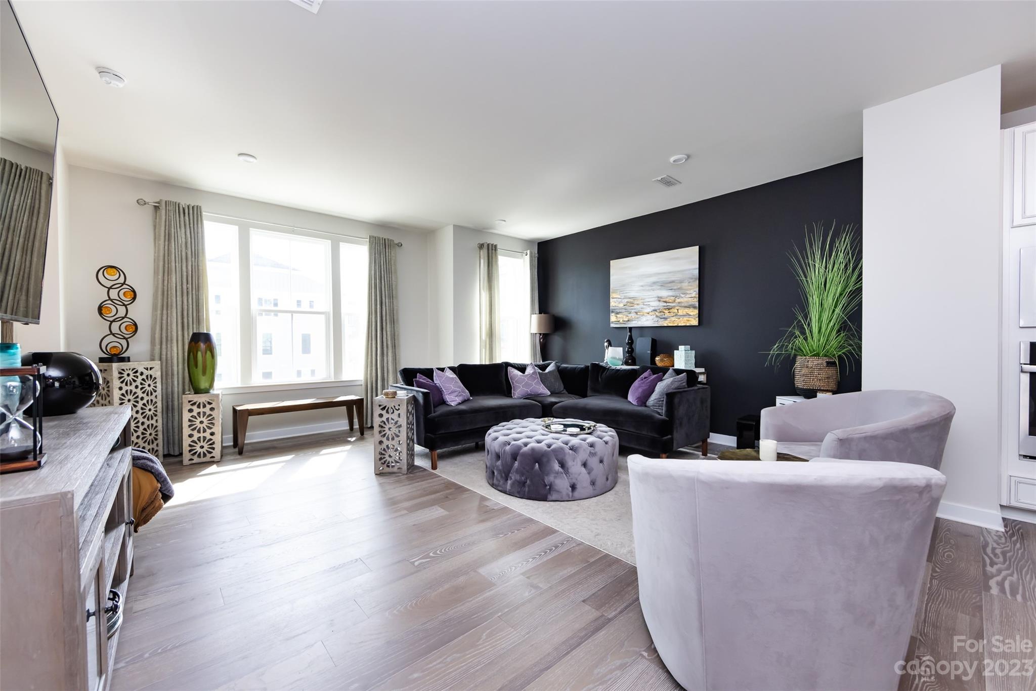 606 Crudent Road Tega Cay, SC 29708 - Photo 19 of 47 a living room with furniture a large window and a flat screen tv