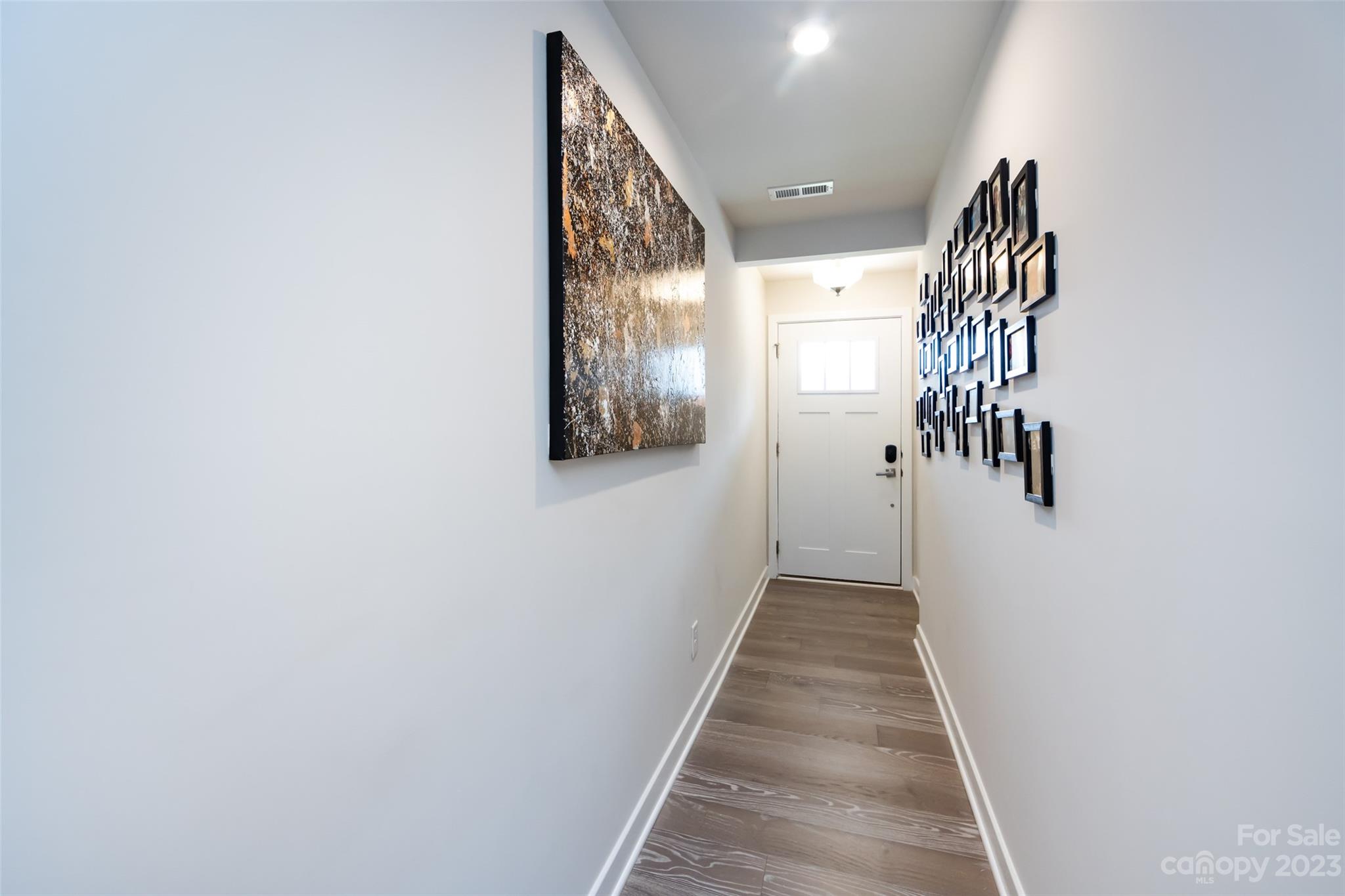 606 Crudent Road Tega Cay, SC 29708 - Photo 3 of 47 a view of a hallway with wooden floor and entryway