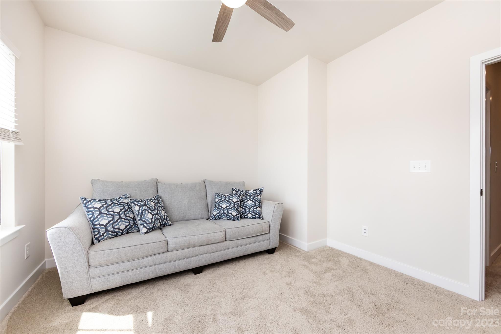606 Crudent Road Tega Cay, SC 29708 - Photo 35 of 47 a living room with furniture and a ceiling fan
