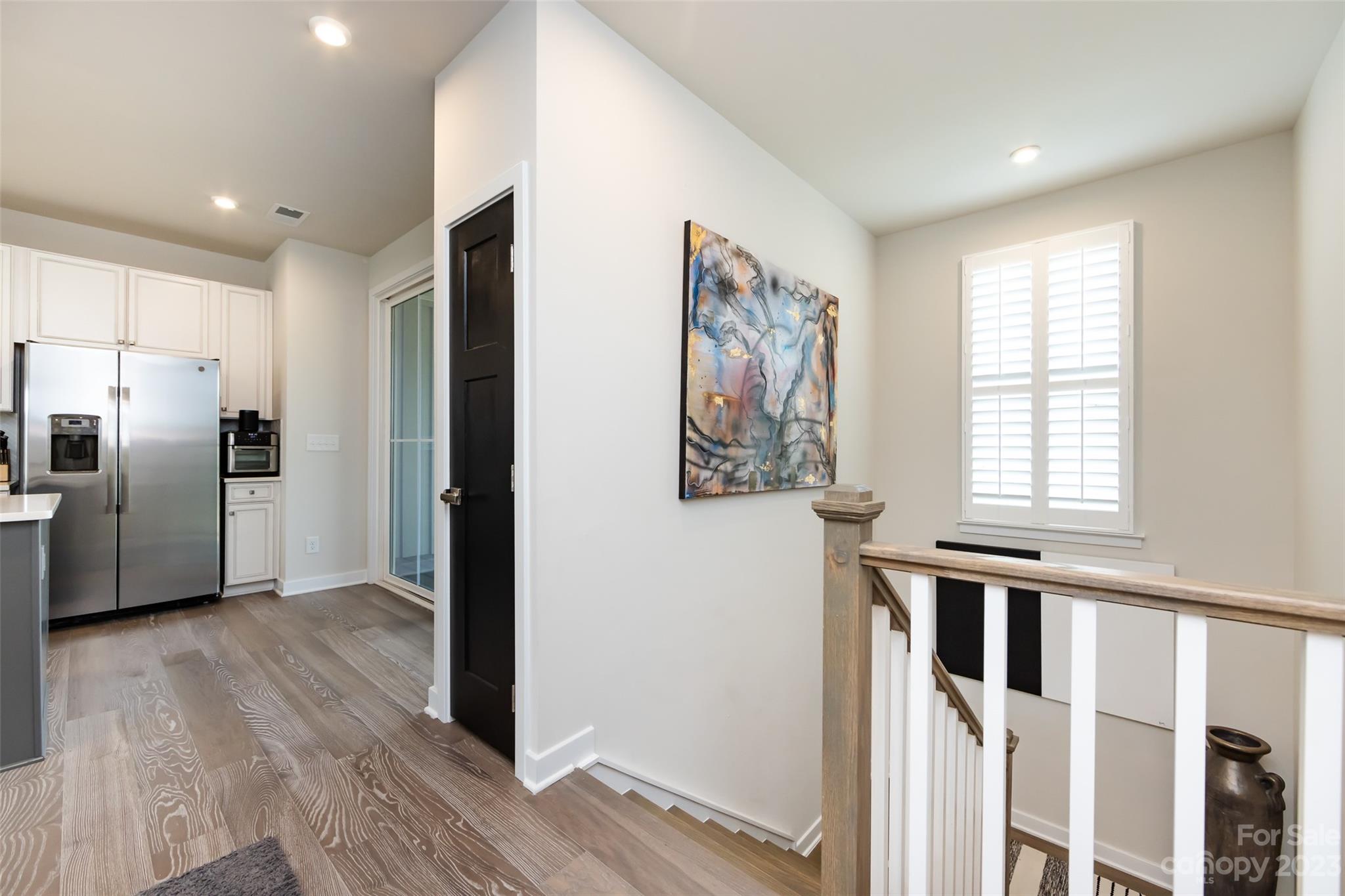 606 Crudent Road Tega Cay, SC 29708 - Photo 6 of 47 a view of a kitchen with wooden floor electronic appliances and windows