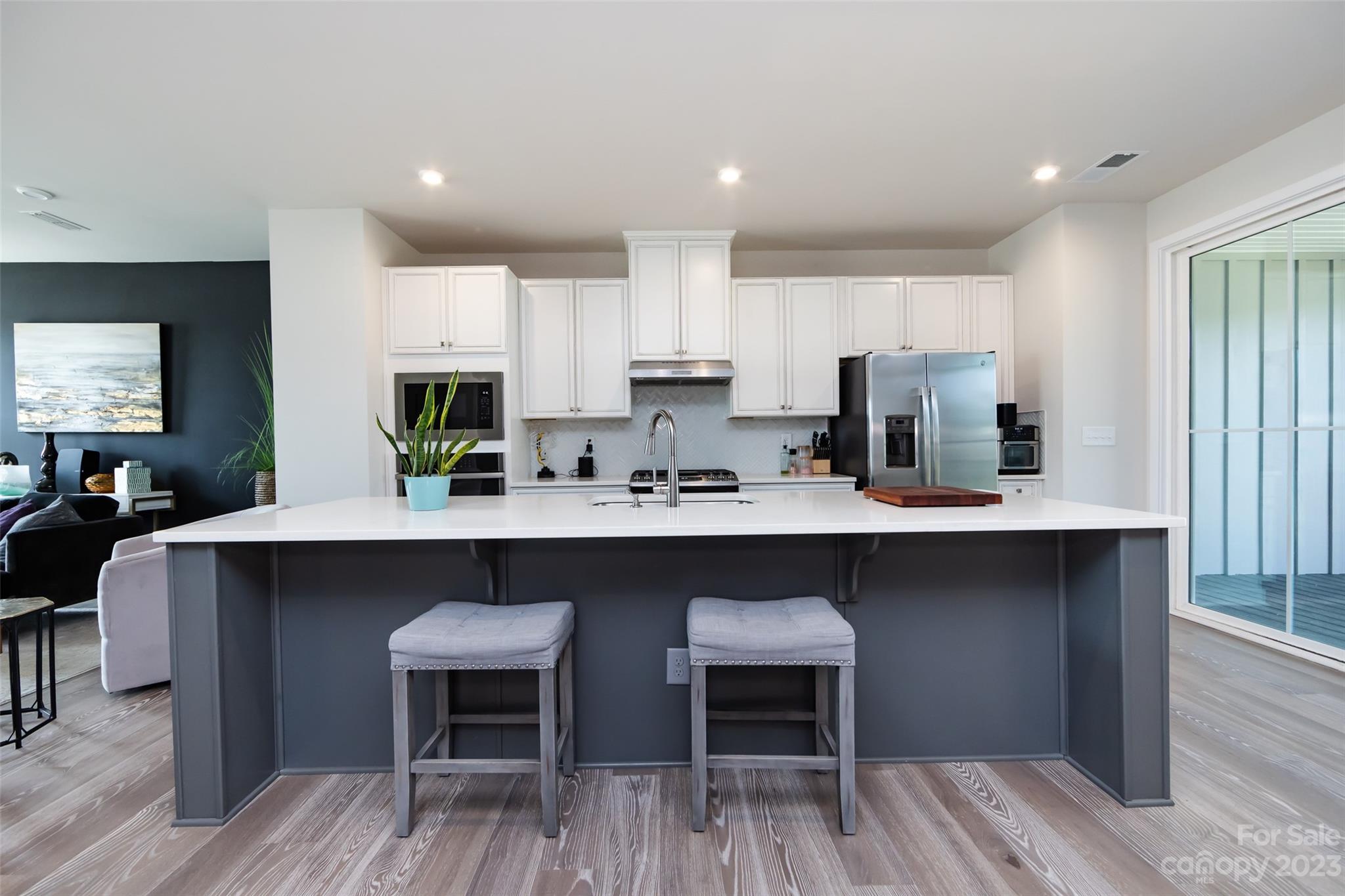606 Crudent Road Tega Cay, SC 29708 - Photo 10 of 47 a kitchen with a sink cabinets and wooden floor