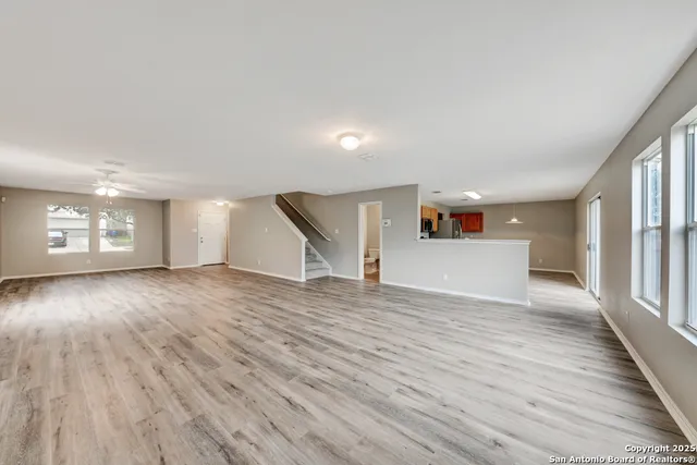 a view of empty room with wooden floor and fireplace