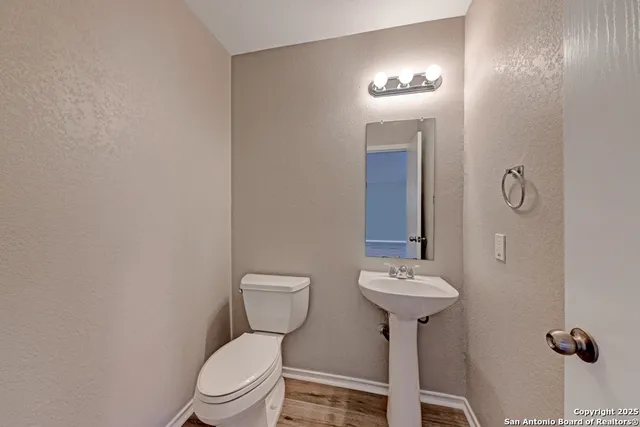 a bathroom with a sink toilet and a mirror