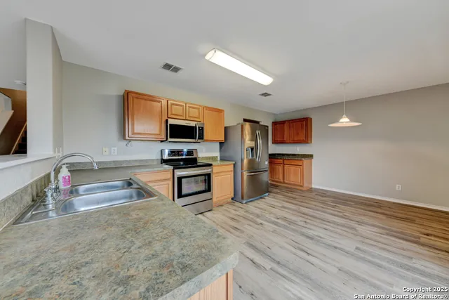 a kitchen with stainless steel appliances a refrigerator and a sink