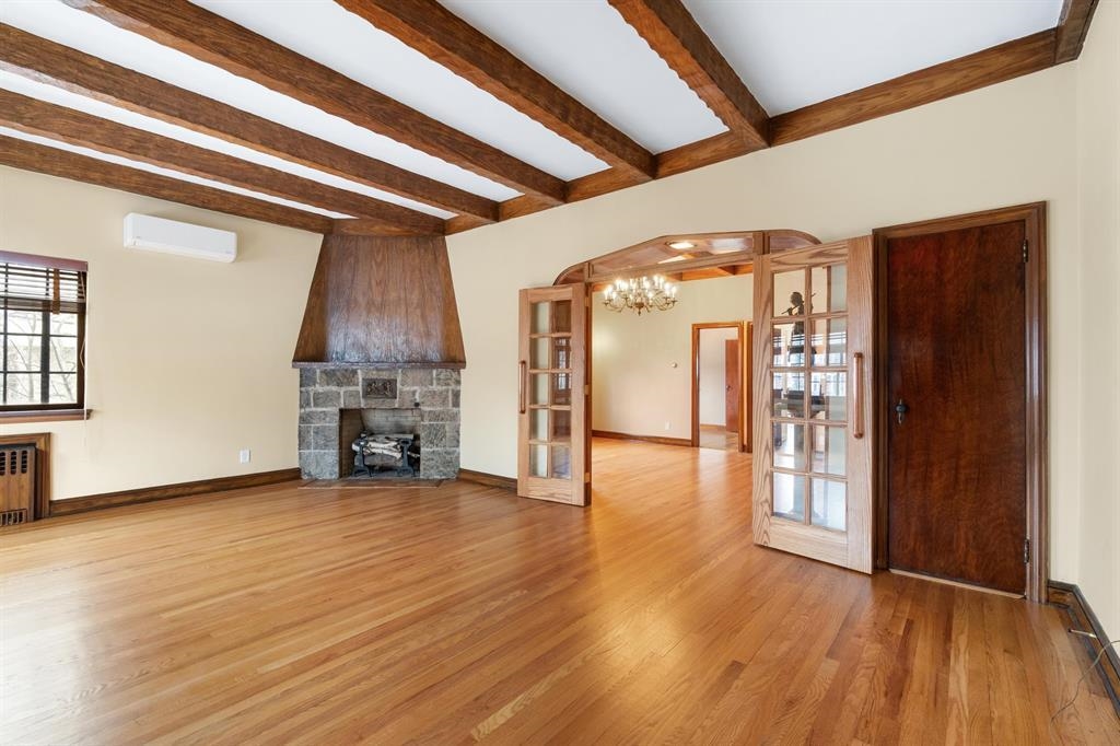 a view of a livingroom with wooden floor and a fireplace