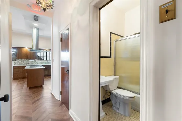 a bathroom with a granite countertop sink toilet and shower