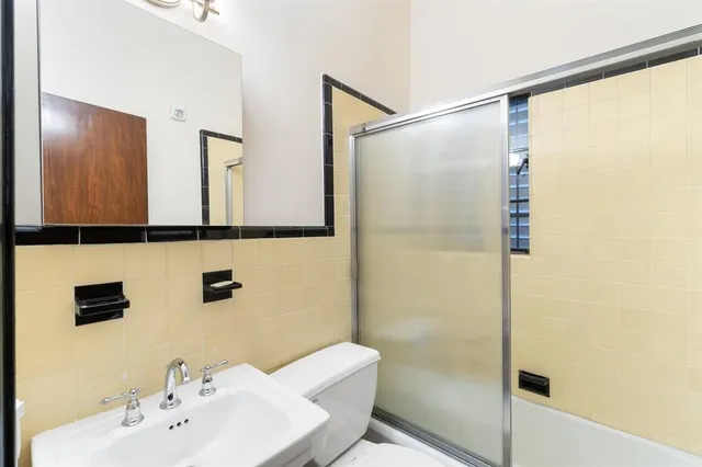 a bathroom with a shower and a sink