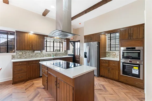 a kitchen with refrigerator cabinets and stove