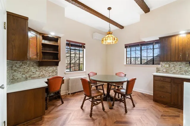 a view of a dining room with furniture and a kitchen