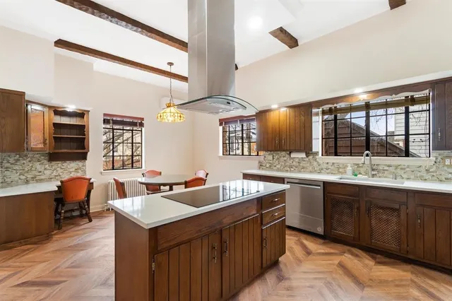 a kitchen with stainless steel appliances granite countertop a sink and a stove