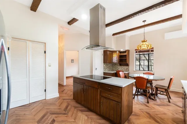 a kitchen with stainless steel appliances kitchen island a refrigerator and a stove