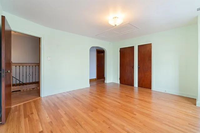 a living room with hard wood floors and a window