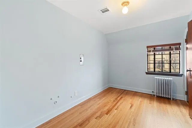 a view of a room with wooden floor and closet