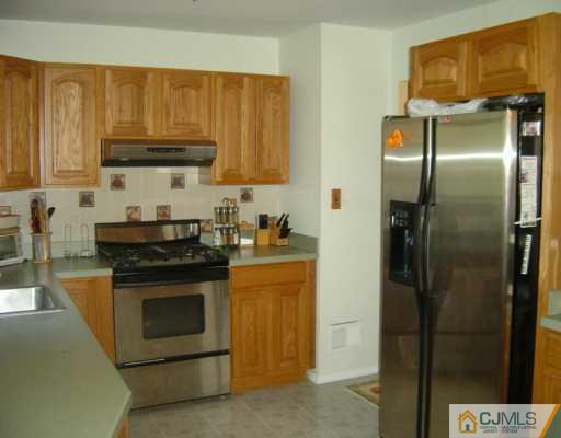 17 Conerly Road Somerset, NJ 08873 - Photo 2 of 6 a kitchen with stainless steel appliances granite countertop a stove a refrigerator and a sink