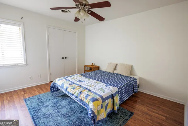 a bed sitting in a bedroom next to a window