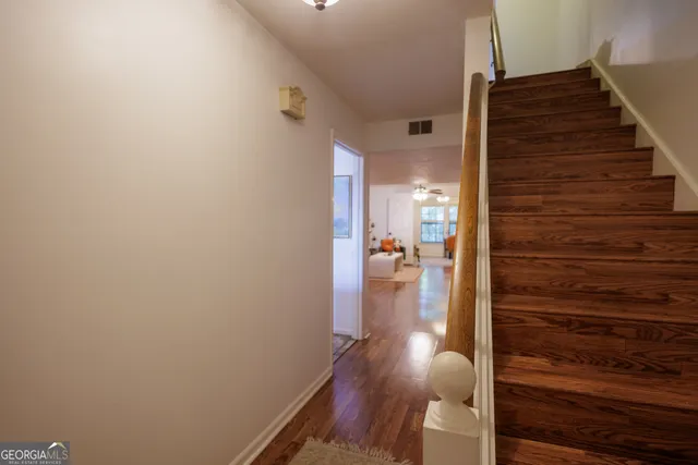 a view of hallway with wooden floor